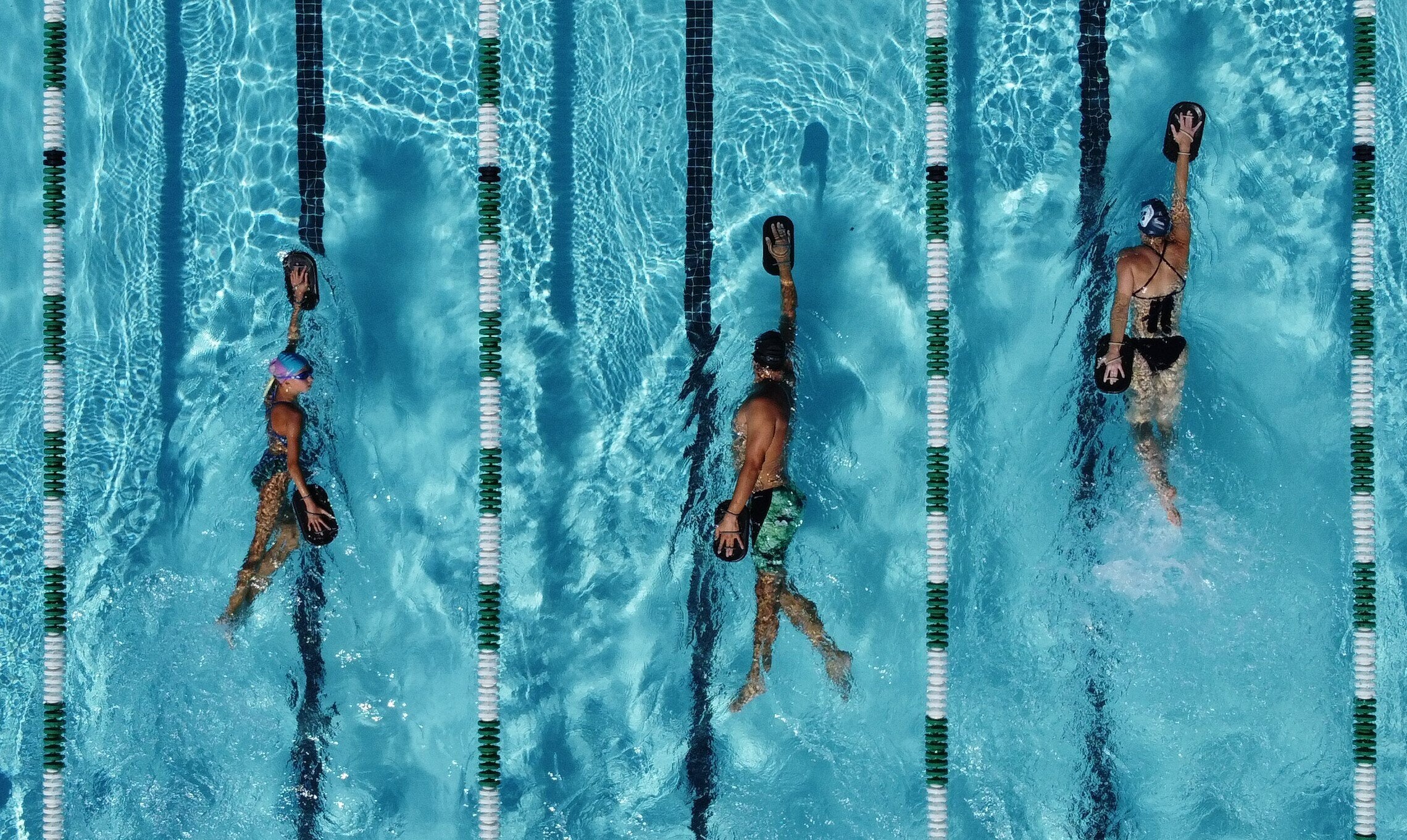 Three swimmers using Dual Boards in the pool.